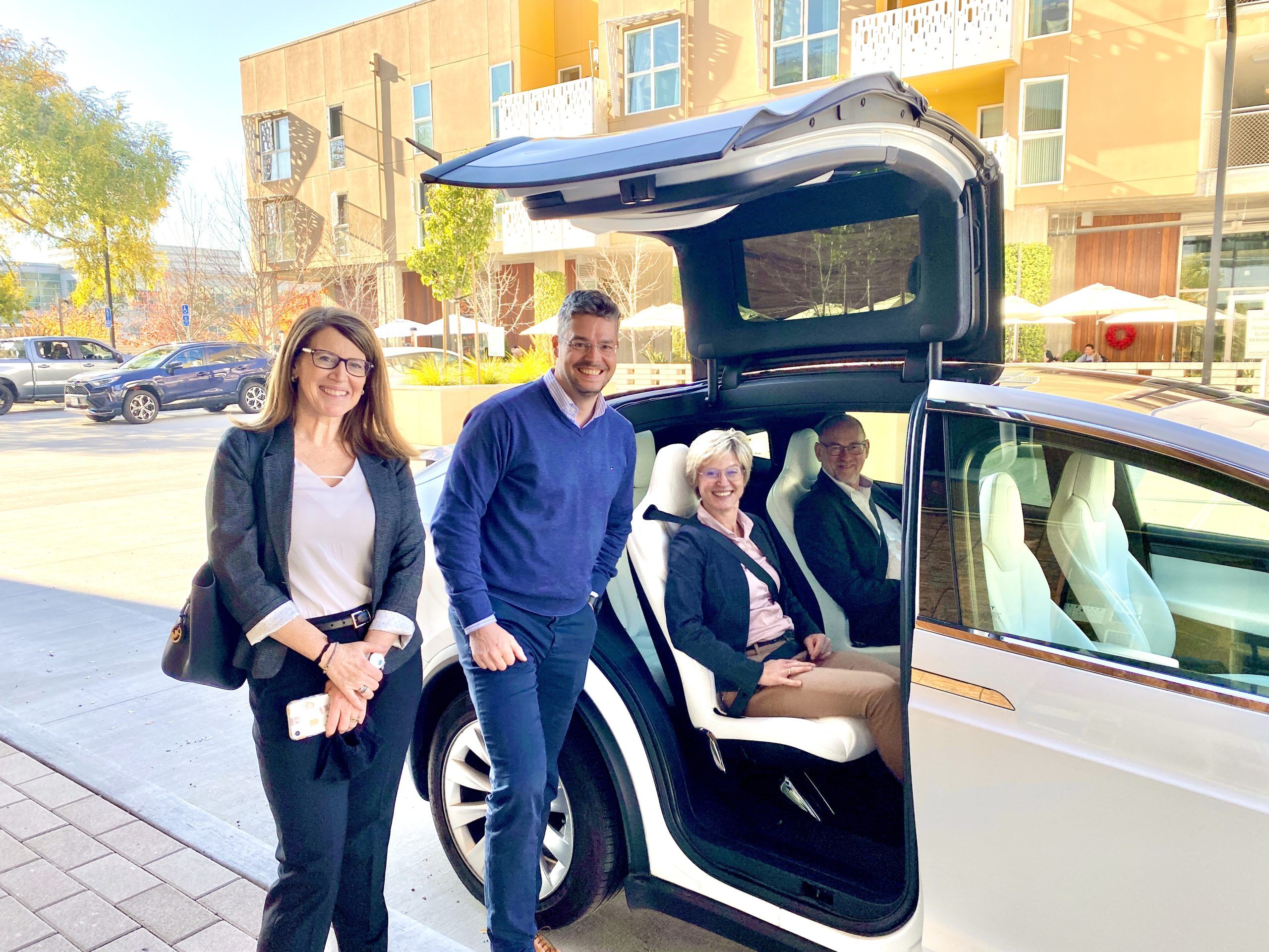 Corporate Group in a Tesla X